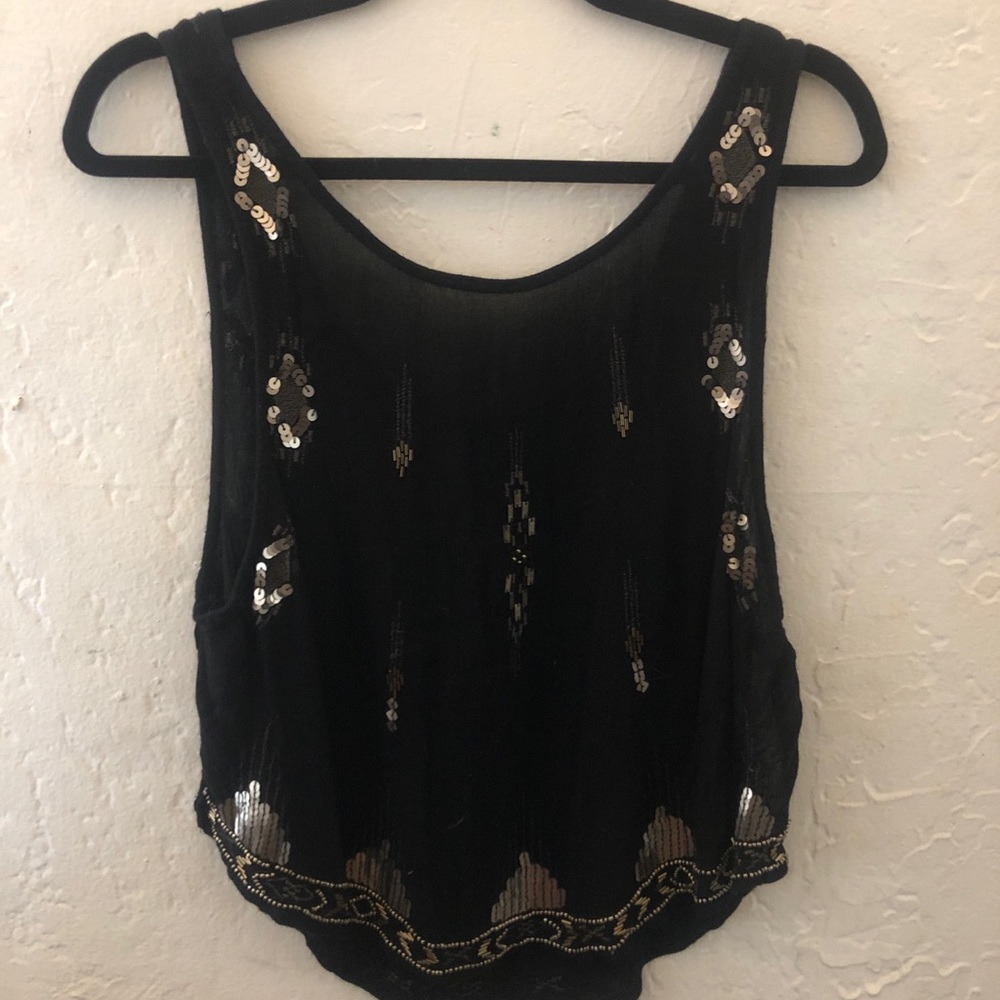 Free People Shirt with sequins and open sides.